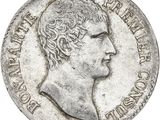 a close up of a silver coin with a man ' s head on it