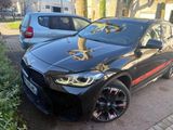 a black bmw suv parked on the side of the road