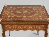 a small wooden table with a decorative design on it