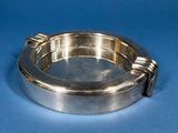 a silver ashtray on a blue background