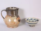 a pitcher and bowl sitting next to each other on a table