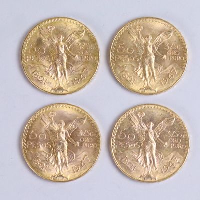 four gold coins of different sizes and shapes on a white surface