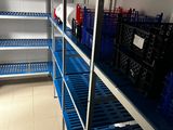 a blue shelf filled with plastic containers and bottles