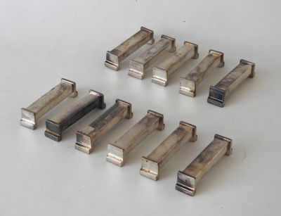 several pieces of metal are arranged on a white surface