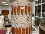 un grand vase posé sur une table dans une pièce