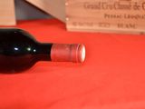 a bottle of wine sitting on a table next to a box of wine