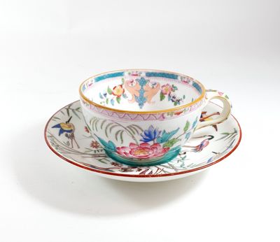 a cup and saucer on a saucer on a white surface