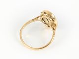 a close up of a gold ring with a pearl in it
