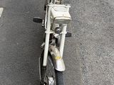motorcycle parked on the side of the road in front of a building