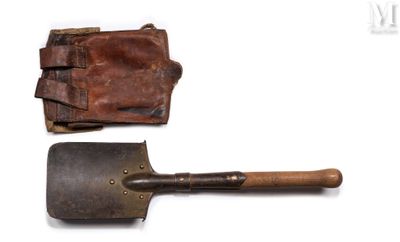 an old pair of shovels and a leather case on a white surface