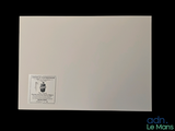 a picture of a white paper with a sticker on it