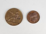 two coins that are sitting side by side on a white surface