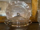 a glass bowl with a lid sitting on a table