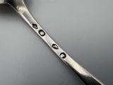a spoon that has some kind of design on it