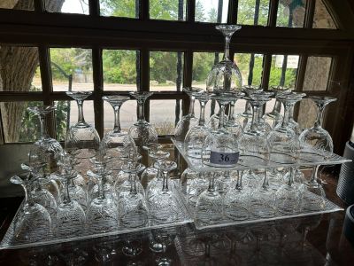 many wine glasses sitting on a table in front of a window