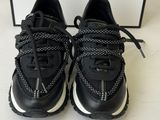 a pair of black and white sneakers on a white surface