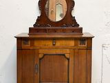 une armoire en bois surmontée d'un miroir