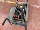 a small cart with tools in it on the floor