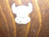 a sticker on the back of a wooden table