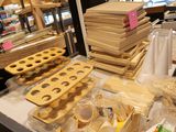 several trays of food are sitting on a table in a store