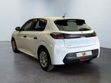 the rear end of a white car parked in a room