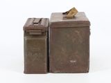 pair of old metal boxes with a piece of paper sticking out of the top