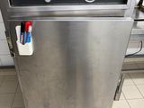a stainless steel dishwasher sitting in the middle of a kitchen