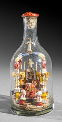 a glass bottle with a miniature ship inside of it