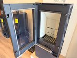 a small refrigerator with a glass door in the middle of a room