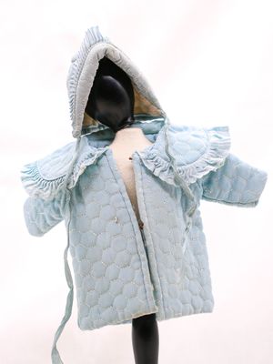 un mannequin vêtu d'un manteau bleu à capuche