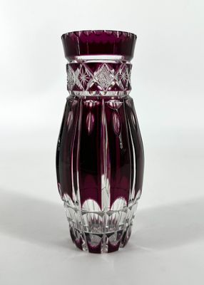 a purple glass vase with a flower design on it