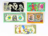 four different types of paper money are displayed on a white surface