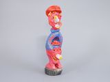 brightly colored figurine of a man with a baseball cap on his head