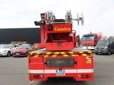 a red fire truck that is parked in a parking lot