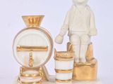 a figurine of a boy standing on a scale