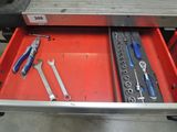 a tool drawer with tools in it in a garage