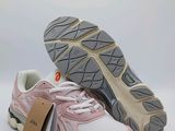 a close up of a pair of pink and white sneakers