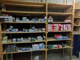 many shelves with various items on them in a room
