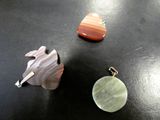 three pieces of jewelry sitting on top of a table next to each other