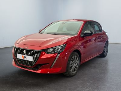 the red car is parked in a large room with a black floor