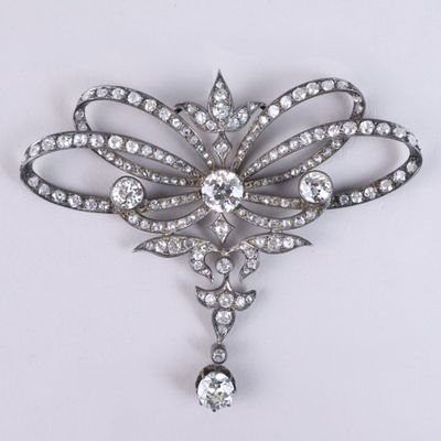a close up of a brooch with diamonds on a white background