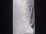 a glass vase filled with water and ice on a table