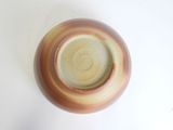a brown and white vase sitting on a white surface