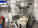 a silver mixer sitting on a counter in a kitchen