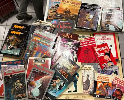 a lot of books that are sitting on the floor