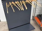 a rack with wooden hangers on it in a store