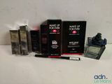 the contents of a make up for ever kit including mascara, eyeliners, and mascara brush