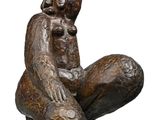 statue of a woman sitting on a rock with her baby in her lap