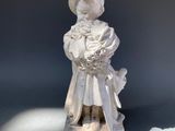 a small statue of a woman holding a baby
