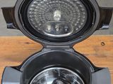 an image of a close up of an air fryer on a wooden table